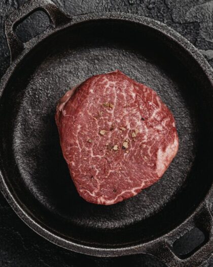 Wild game meat in an iron skillet - Canadian Cuisine from Hooke, Robert Rose Cookbooks