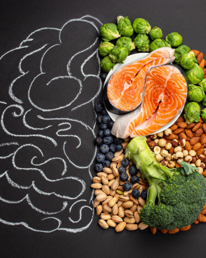 brain-healthy foods arranged in a sketch of a brain - salmon, broccoli, nuts, greens